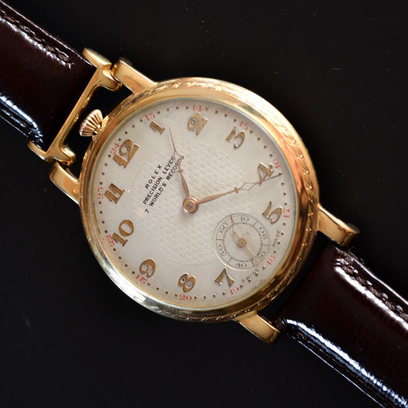 Rolex 1920s trench watch, angled front view showing guilloche dial with applied gold numerals and sub-seconds register