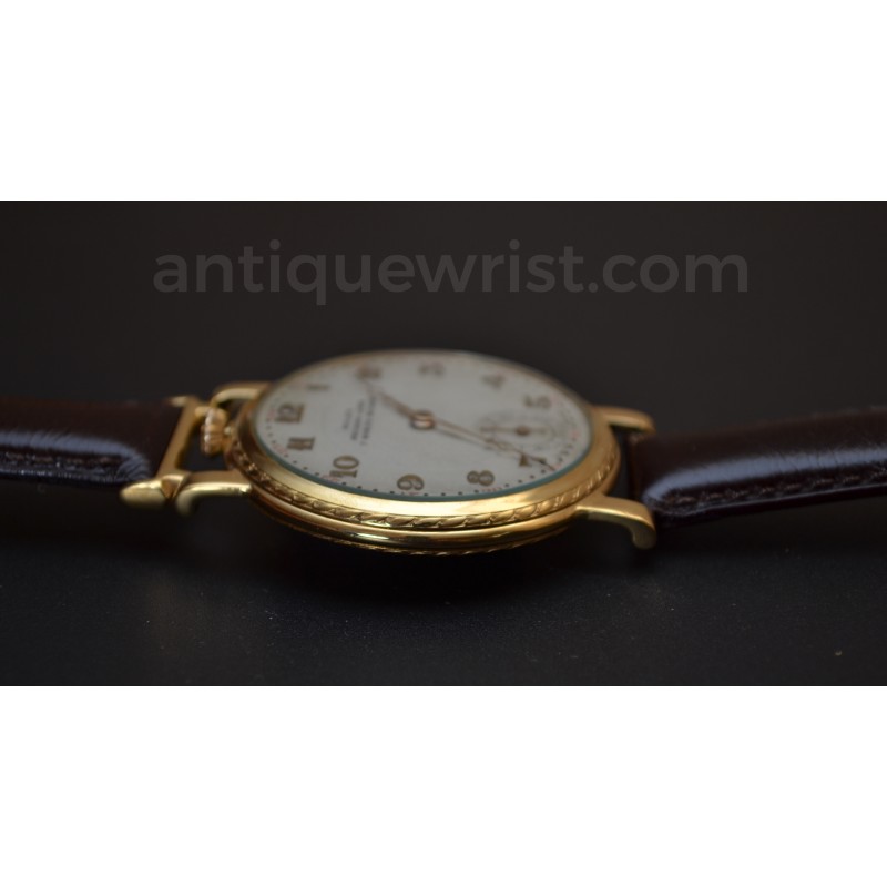 Rolex 1920s trench watch profile view on leather strap, showing slim case height and guilloche bezel, circa 1920s