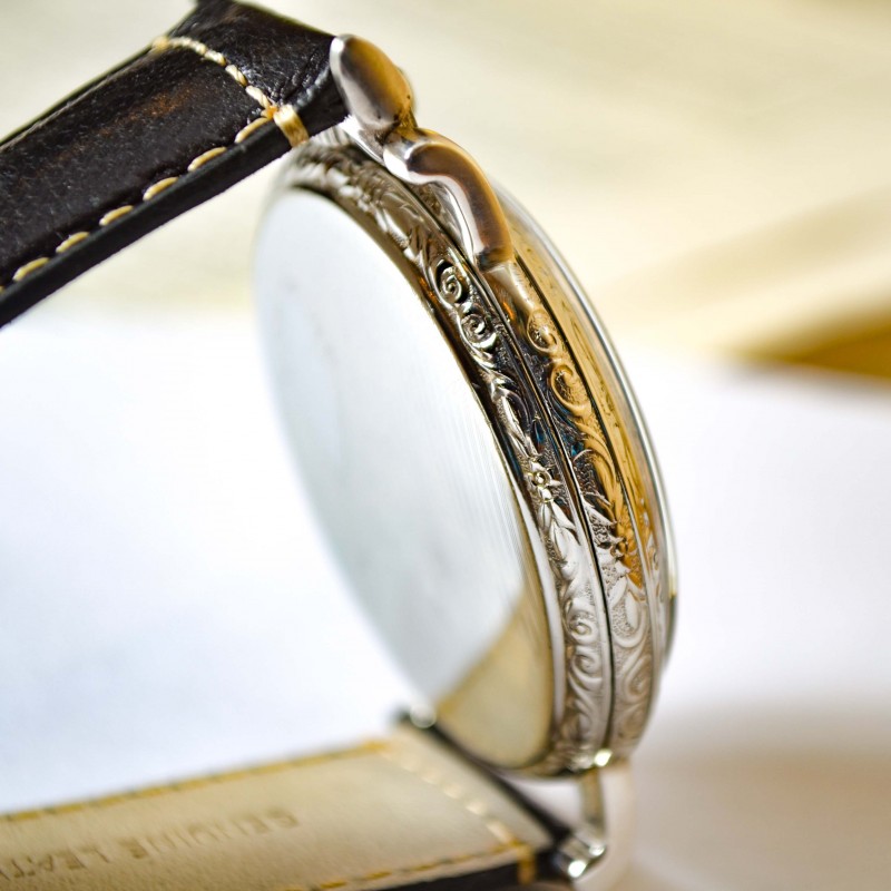 Rolex Unicorn 45mm case side view showing art deco guilloche bezel engraving and wire lug construction detail, circa 1930s