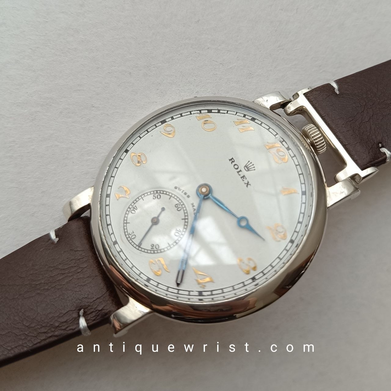 Vintage military Rolex watch with 48mm nickel-chrome case, beige dial, gilt Arabic numerals, and blued steel sword hands.