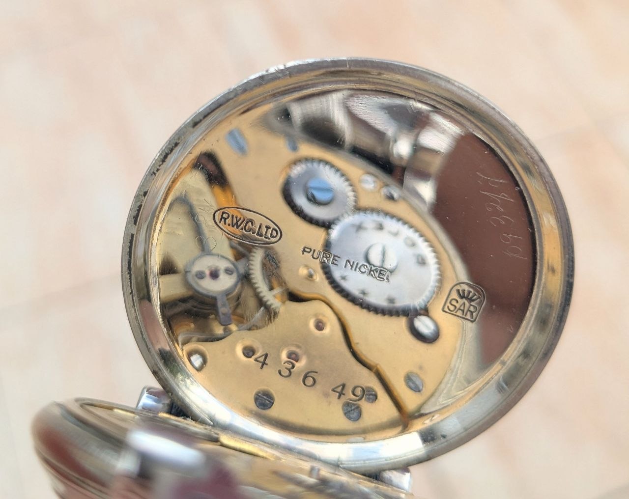 Swiss Rolex hallmarks and case markings, SAR RWCo Ltd stamps on 43mm nickel military chronometer