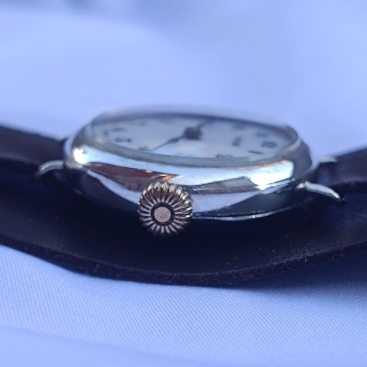 Side profile of antique Rolex Rolco 27mm silver case with welded wire lugs and original gold-plated winding crown.