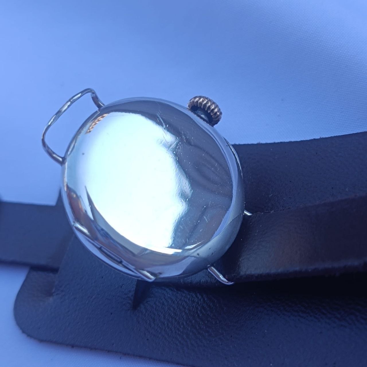 Back cover of 1916 Rolex Rolco with polished sterling silver surface and engraved case back, no visible hallmarks on exterior.