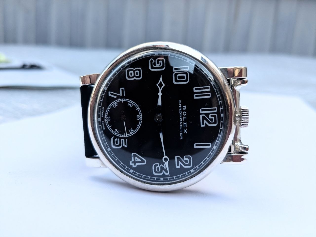 Vintage Rolex Marconi chronometer front view, black military dial with Arabic numerals, 47.5mm solid silver case